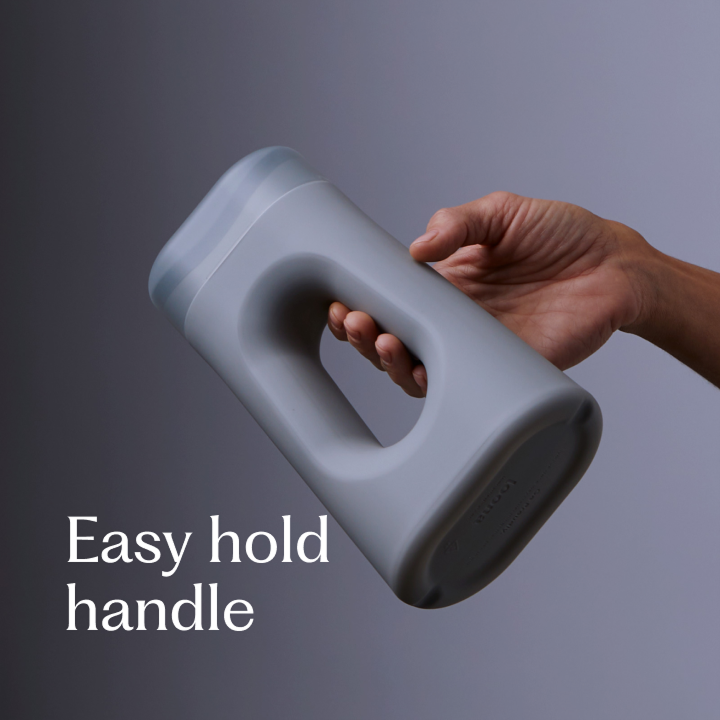 Hand gripping the gray Loona through its integrated oval handle, demonstrating the easy-hold ergonomic design