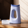 Periwinkle Loona female urinal on a wooden bedside table with its frosted snap-close lid resting beside it