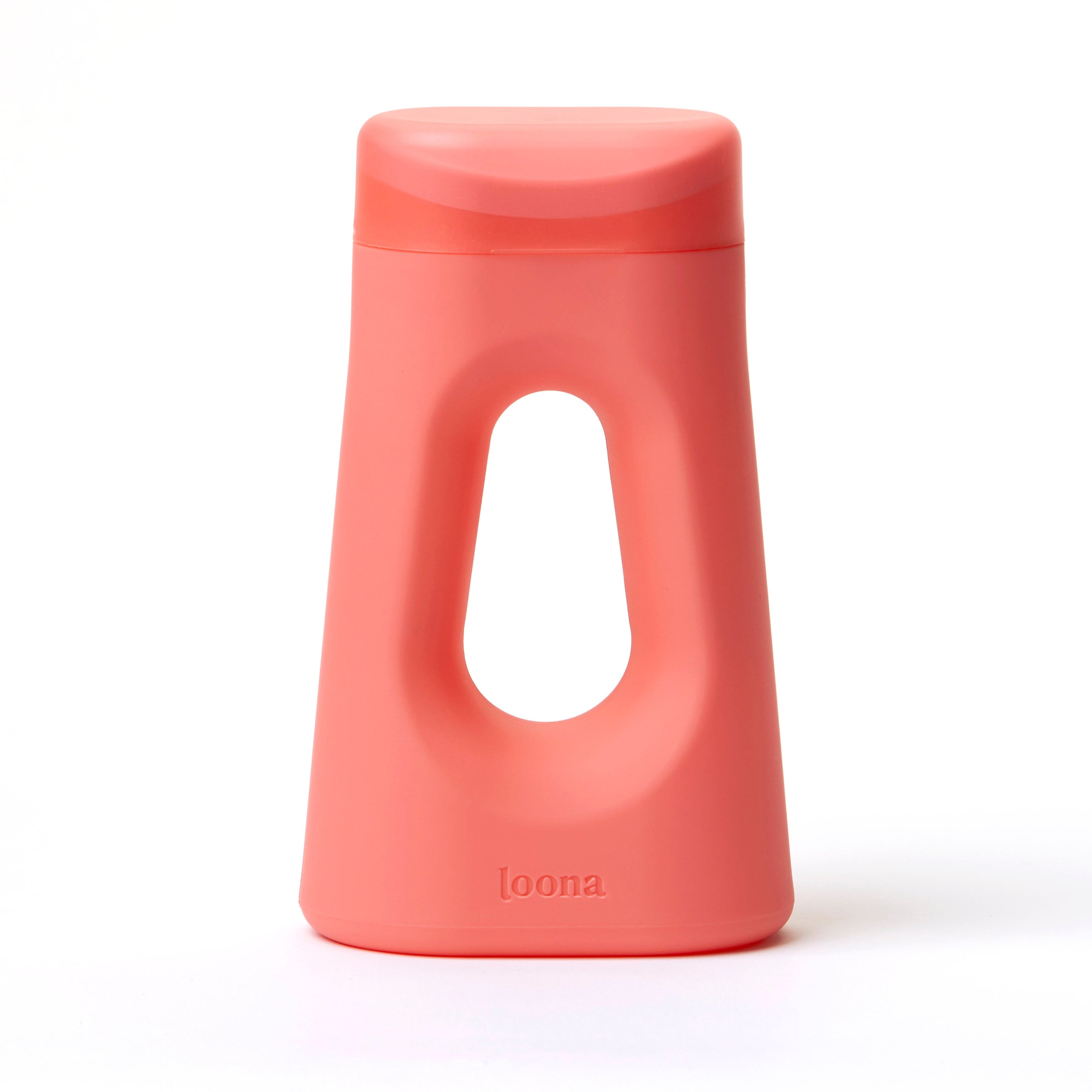 Front view of the Loona female urinal in coral pink on a white background, showing the contoured body, integrated handle, and snap-close lid